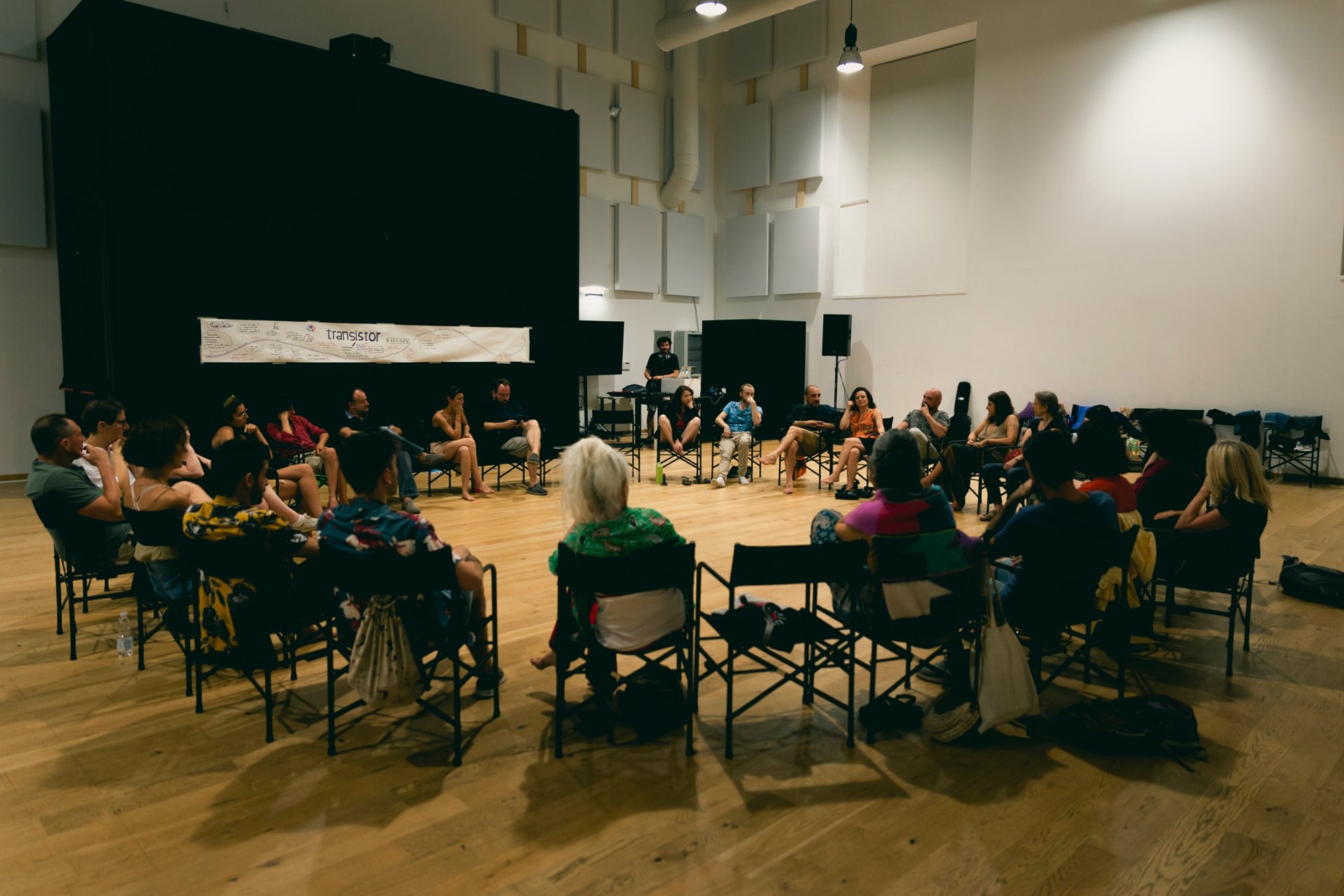 People sitting in a circle during a Transistor Firenze meeting